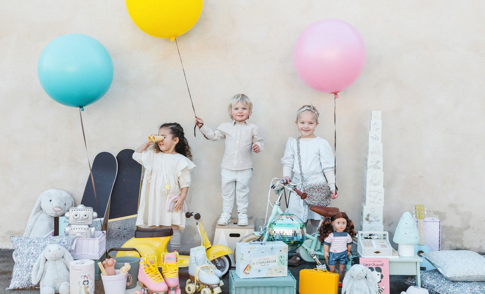 Børn med balloner og masser af legetøj til ønskelisten